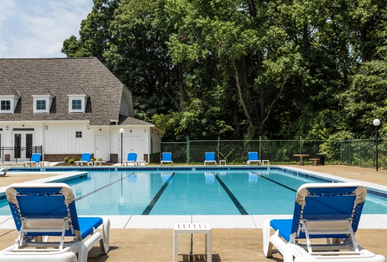 pool, blue lounge chairs, and clubhouse at The Residences at Brookside
