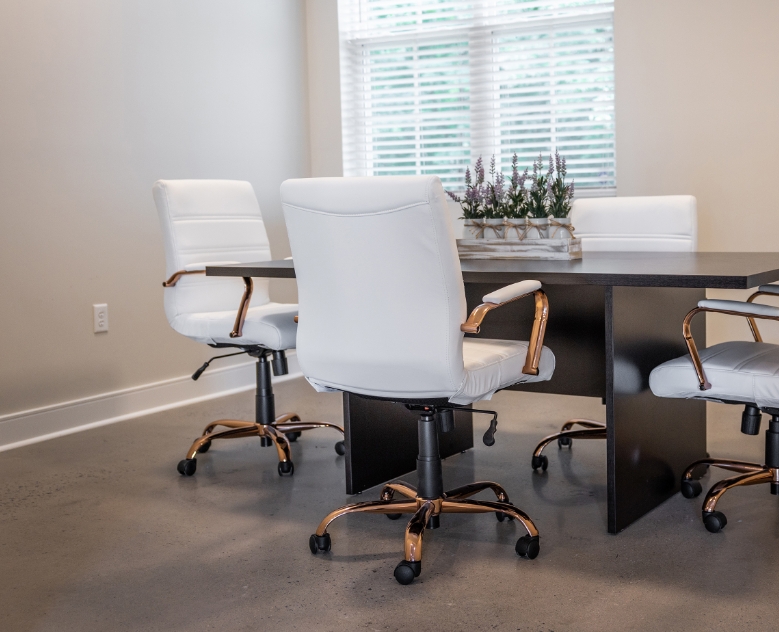 white office chairs around a conference table at The Residences at Brookside