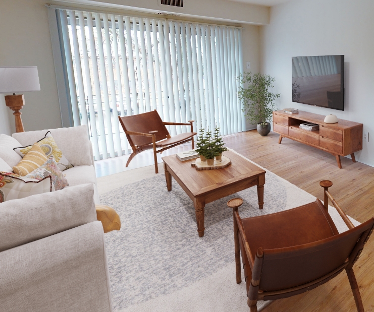 white couch and wood table in front of television in a living room at The Residences at Brookside